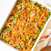 the finished Cheesy Green Bean Casserole with Bacon in a ceramic casserole dish, ready for presenting and serving on your Thanksgiving table.