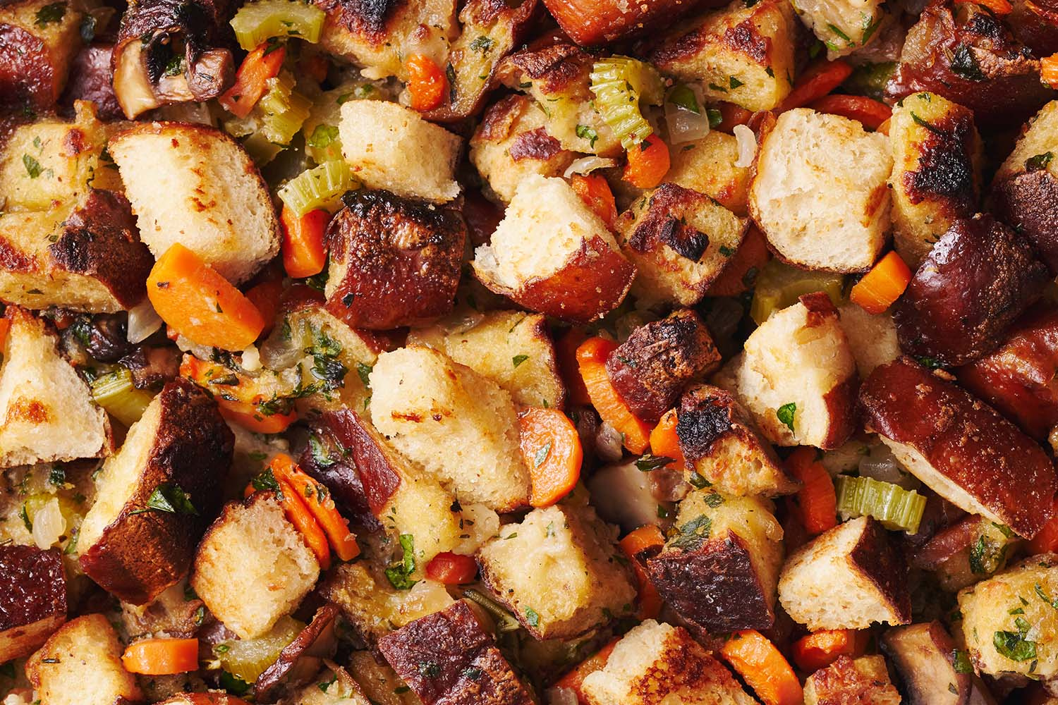 close-up photo of the pretzel stuffing after being baked, showing the cubed pretzels and cooked veggies and herbs.
